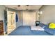 Bedroom with blue bedding, closet, and natural light at 316 Bennett St, Auburndale, FL 33823