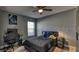 Cozy bedroom featuring wood-look floors, grey walls, and a ceiling fan at 316 Bennett St, Auburndale, FL 33823