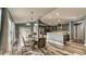 Dining area featuring a glass table, wood floors, and a view of the kitchen with stainless steel appliances at 316 Bennett St, Auburndale, FL 33823