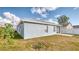 The light blue exterior of this home is accentuated by white windows and a white roof at 316 Bennett St, Auburndale, FL 33823