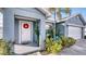 Welcoming front entrance featuring a decorative wreath and lush landscaping at 316 Bennett St, Auburndale, FL 33823