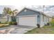 A two-car garage with a freshly painted white door that matches the house's trim at 316 Bennett St, Auburndale, FL 33823