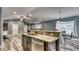 Open-concept space with a kitchen island and bar seating, perfect for entertaining guests at 316 Bennett St, Auburndale, FL 33823