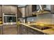 Close-up of the kitchen area, showcasing the oven, stovetop, and granite countertops at 316 Bennett St, Auburndale, FL 33823