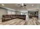 Spacious living room with sleek flooring, comfortable seating, and seamless flow to the kitchen at 316 Bennett St, Auburndale, FL 33823