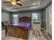 Bright bedroom with tray ceiling, ceiling fan, wood-look floors, and two windows at 316 Bennett St, Auburndale, FL 33823