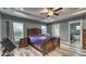 Spacious bedroom with tray ceiling, ceiling fan, wood-look floors, and ensuite bathroom at 316 Bennett St, Auburndale, FL 33823
