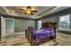Spacious bedroom with tray ceiling, ceiling fan, and wood-look floors at 316 Bennett St, Auburndale, FL 33823