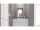 Bathroom with white cabinets, gray countertops, and modern fixtures create an inviting space at 326 Puma Loop, Groveland, FL 34736