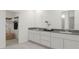 This bathroom is designed with double sinks and ample storage, providing convenience and style at 326 Puma Loop, Groveland, FL 34736