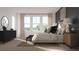 Bright bedroom showcasing large windows, a comfortable bed, and chic decor for a serene living space at 326 Puma Loop, Groveland, FL 34736