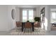Modern dining room featuring a black table, six chairs, and a large window with natural light at 326 Puma Loop, Groveland, FL 34736