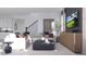 Contemporary living room featuring stylish seating, modern decor, and a flat-screen TV for entertainment at 326 Puma Loop, Groveland, FL 34736