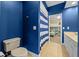 Blue bathroom featuring a toilet, vanity, and view to bedroom at 3267 Regal Crest Dr, Longwood, FL 32779