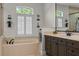 Relaxing bathtub with designer fixtures and shelving at 3267 Regal Crest Dr, Longwood, FL 32779