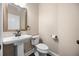 Elegant powder room with pedestal sink, dark wood floors, and neutral colored walls at 3267 Regal Crest Dr, Longwood, FL 32779