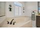 Bathroom features a soaking tub with modern fixtures and a bright window at 3267 Regal Crest Dr, Longwood, FL 32779