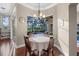 Bright breakfast nook features backyard pool view, wood floors, and modern light fixture at 3267 Regal Crest Dr, Longwood, FL 32779