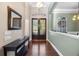 Inviting foyer with hardwood floors, stylish console table, and decorative lighting at 3267 Regal Crest Dr, Longwood, FL 32779