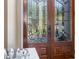Elegant, close up view of a carved wooden front door with stained glass panels at 3267 Regal Crest Dr, Longwood, FL 32779