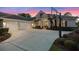 Beautiful home exterior showcasing a spacious driveway, three-car garage, and meticulously maintained landscaping at 3267 Regal Crest Dr, Longwood, FL 32779