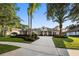 Beautiful home exterior with lush landscaping, mature palm trees, and a circular driveway creating an inviting entrance at 3267 Regal Crest Dr, Longwood, FL 32779