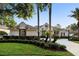 Inviting home with manicured landscaping, mature palm trees, and a circular driveway creating an attractive exterior at 3267 Regal Crest Dr, Longwood, FL 32779