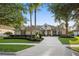 Inviting home exterior with swaying palm trees, lush landscaping, and a circular driveway enhancing curb appeal at 3267 Regal Crest Dr, Longwood, FL 32779