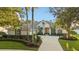 Inviting home with beautiful landscaping, swaying palm trees, and a circular driveway creating an attractive exterior at 3267 Regal Crest Dr, Longwood, FL 32779