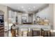 Bright kitchen features granite countertops, stainless steel appliances, white cabinets, and a breakfast bar with seating at 3267 Regal Crest Dr, Longwood, FL 32779