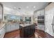 Open kitchen layout featuring an island, white cabinets, granite countertops, and stainless appliances at 3267 Regal Crest Dr, Longwood, FL 32779