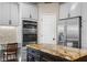 Modern kitchen with built-in double oven and stainless steel refrigerator at 3267 Regal Crest Dr, Longwood, FL 32779
