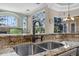 Granite kitchen countertop with stainless steel sink and bronze faucet at 3267 Regal Crest Dr, Longwood, FL 32779