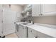Bright laundry room with modern washer and dryer, storage cabinets, and counter space at 3267 Regal Crest Dr, Longwood, FL 32779