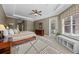 Main bedroom with tray ceiling, bright windows, and access to the lanai at 3267 Regal Crest Dr, Longwood, FL 32779