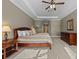 Main bedroom with tray ceiling, comfortable bed, and dresser at 3267 Regal Crest Dr, Longwood, FL 32779