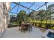 Outdoor seating area featuring a table and chairs set under a screened enclosure with golf course views at 3267 Regal Crest Dr, Longwood, FL 32779