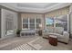 Bright sitting area with a comfortable sofa and ottoman, overlooking a landscaped yard at 3267 Regal Crest Dr, Longwood, FL 32779