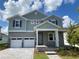 Charming two-story home with a two-car garage and inviting front porch at 335 Ridgemark Ave, Groveland, FL 34736