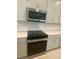 Close-up of the kitchen featuring stainless steel microwave and electric range at 335 Ridgemark Ave, Groveland, FL 34736