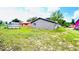 Backyard showing lawn space, wood fence, and neighborhood with colorful homes at 3362 Janet St, Apopka, FL 32712