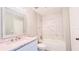 Bathroom features white vanity with gray countertop, white tiled bathtub, and stainless steel fixtures at 3362 Janet St, Apopka, FL 32712