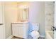 Bathroom featuring white vanity with gray countertop, white tiled bathtub, and stainless steel fixtures at 3362 Janet St, Apopka, FL 32712