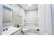 Bright bathroom with white tiled shower/tub and white marble-look tiled floor at 3362 Janet St, Apopka, FL 32712
