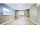 Bedroom featuring wood-look tile flooring, light gray walls, and two windows at 3362 Janet St, Apopka, FL 32712