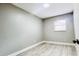 Neutral bedroom featuring wood-look tile flooring, light gray walls, and a window at 3362 Janet St, Apopka, FL 32712