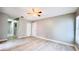 Bedroom featuring wood-look tile flooring, light gray walls, and a ceiling fan with light at 3362 Janet St, Apopka, FL 32712