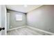 Cozy bedroom features a light gray color scheme, bright light and wood-look tiled floors at 3362 Janet St, Apopka, FL 32712
