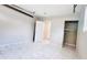 Attached garage with closet space, white marble-look tiled floor, and open door to house at 3362 Janet St, Apopka, FL 32712