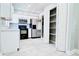 Bright kitchen featuring white cabinets, stainless steel appliances, and tiled floors at 3362 Janet St, Apopka, FL 32712